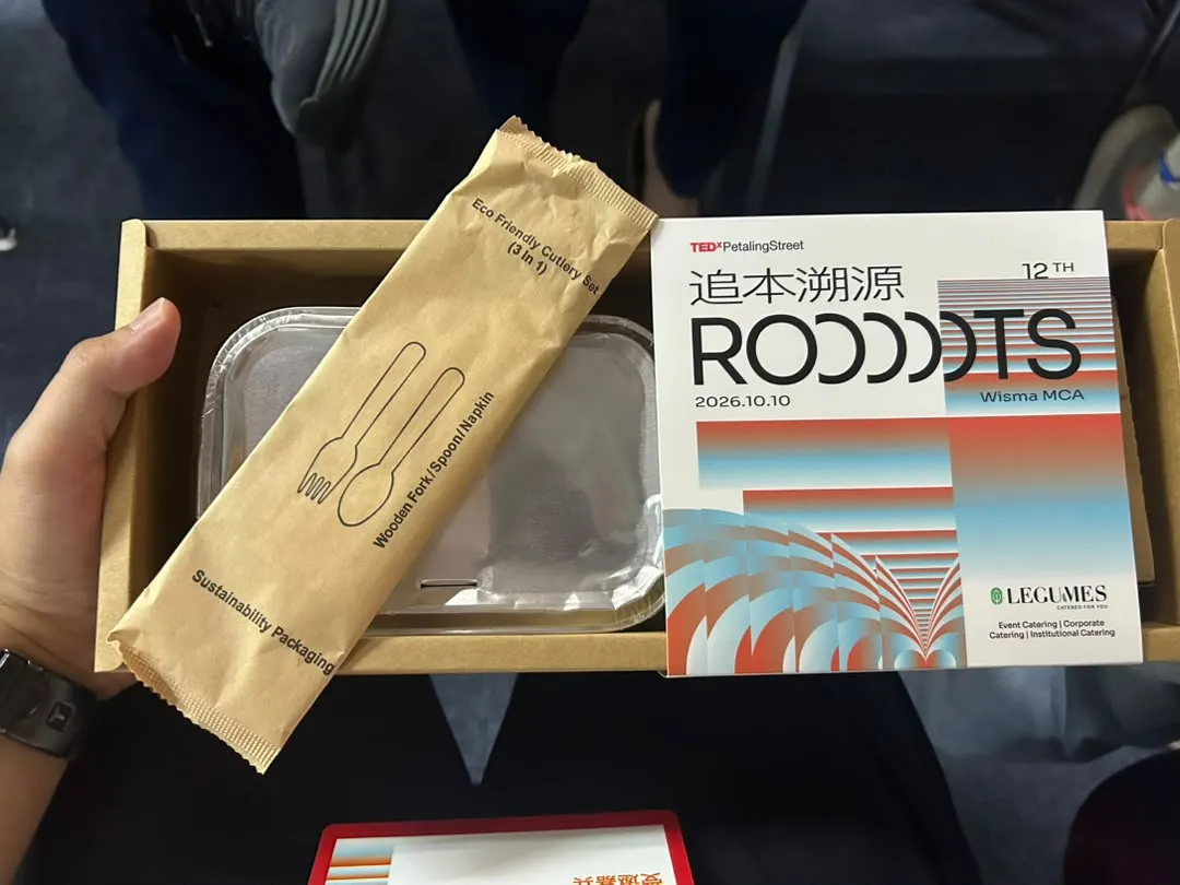 A TEDxPetalingStreet 2026 conference lunch box with a ThreeCo 3-in-1 wooden fork, spoon and napkin cutlery set