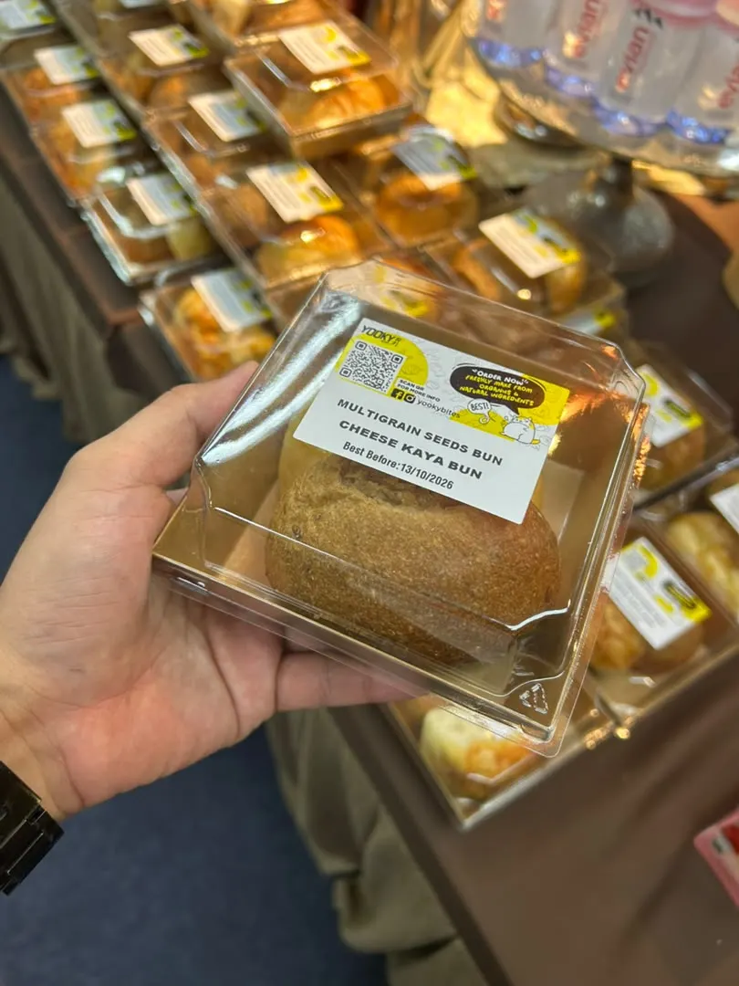 Multigrain and cheese kaya buns served to attendees in clear food boxes at TEDxPetalingStreet 2026